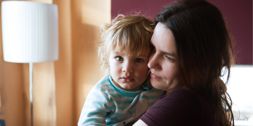 Close up of woman and child hugging