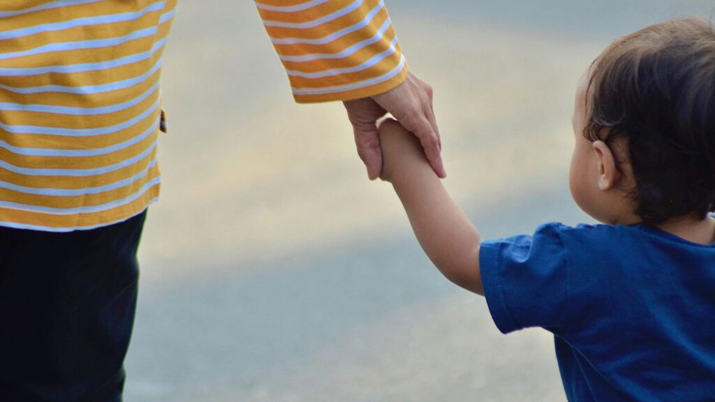 Small child holding an adults hand